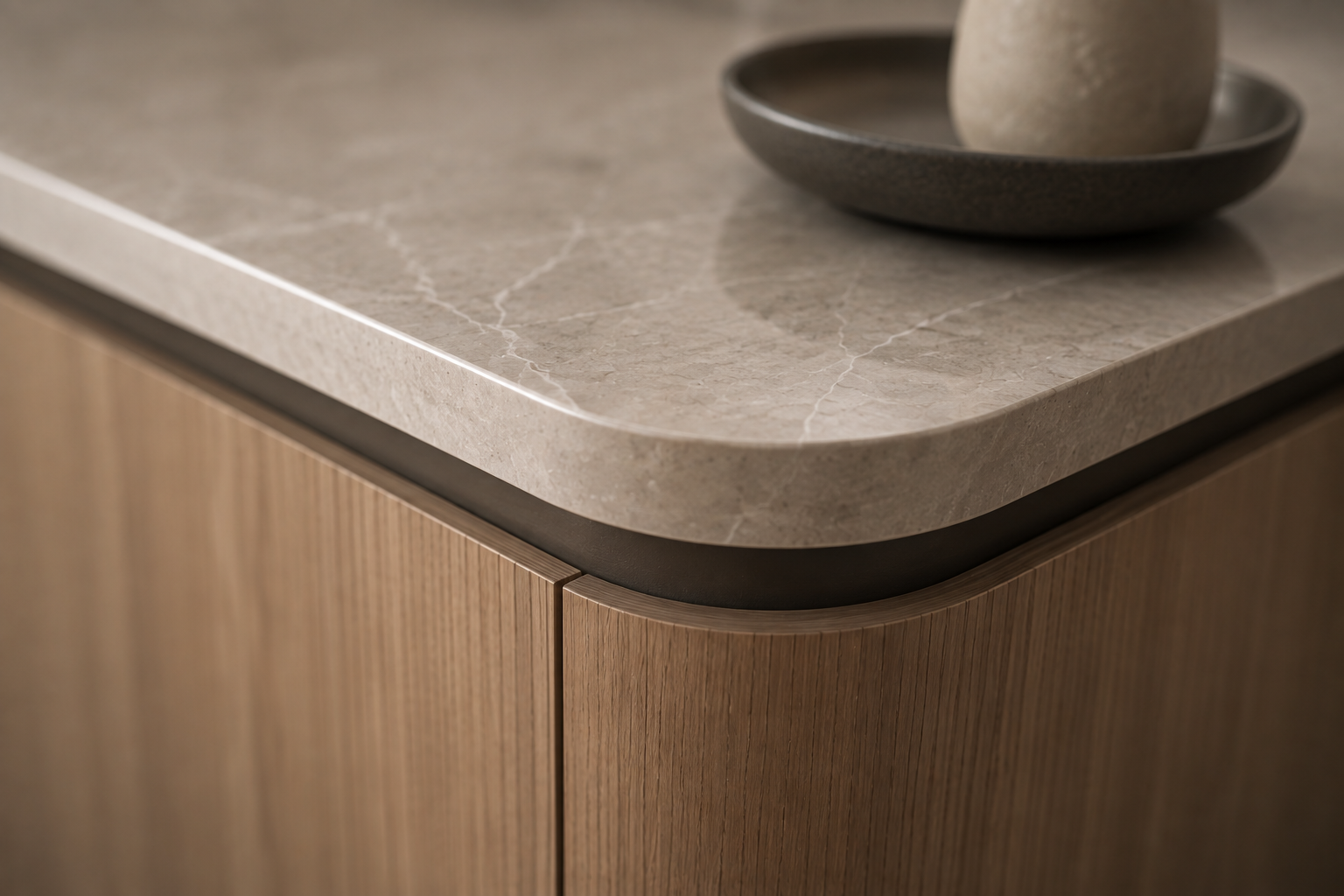 Curved timber cabinetry corner with stone benchtop and shadow-line detail