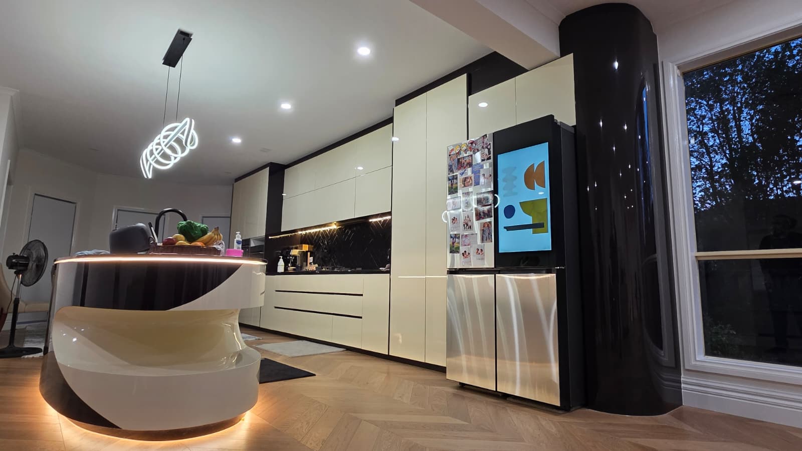 Completed curved island kitchen with integrated lighting