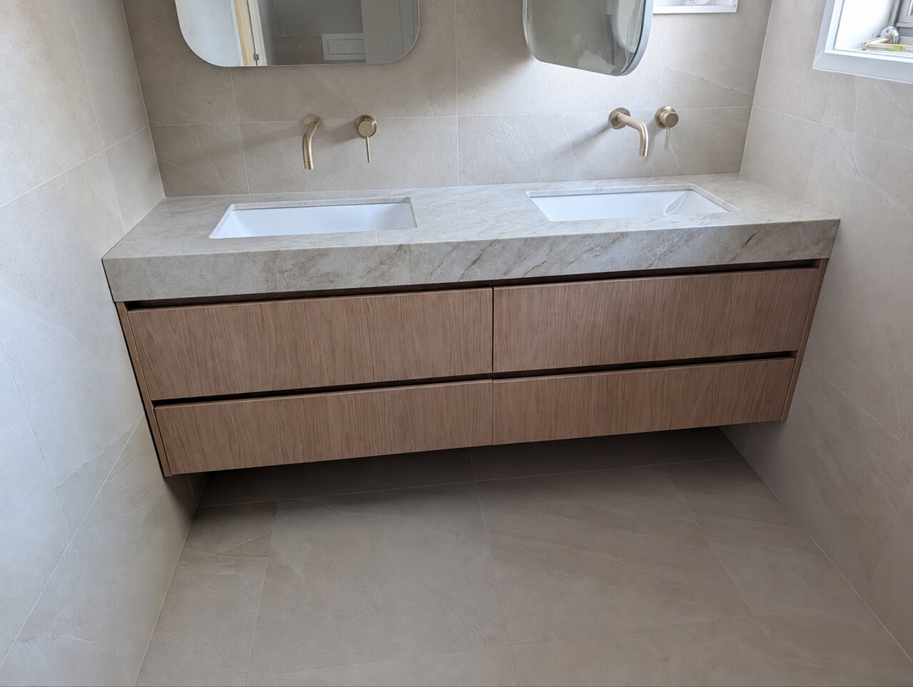Completed wall-hung double vanity with timber-look drawer fronts
