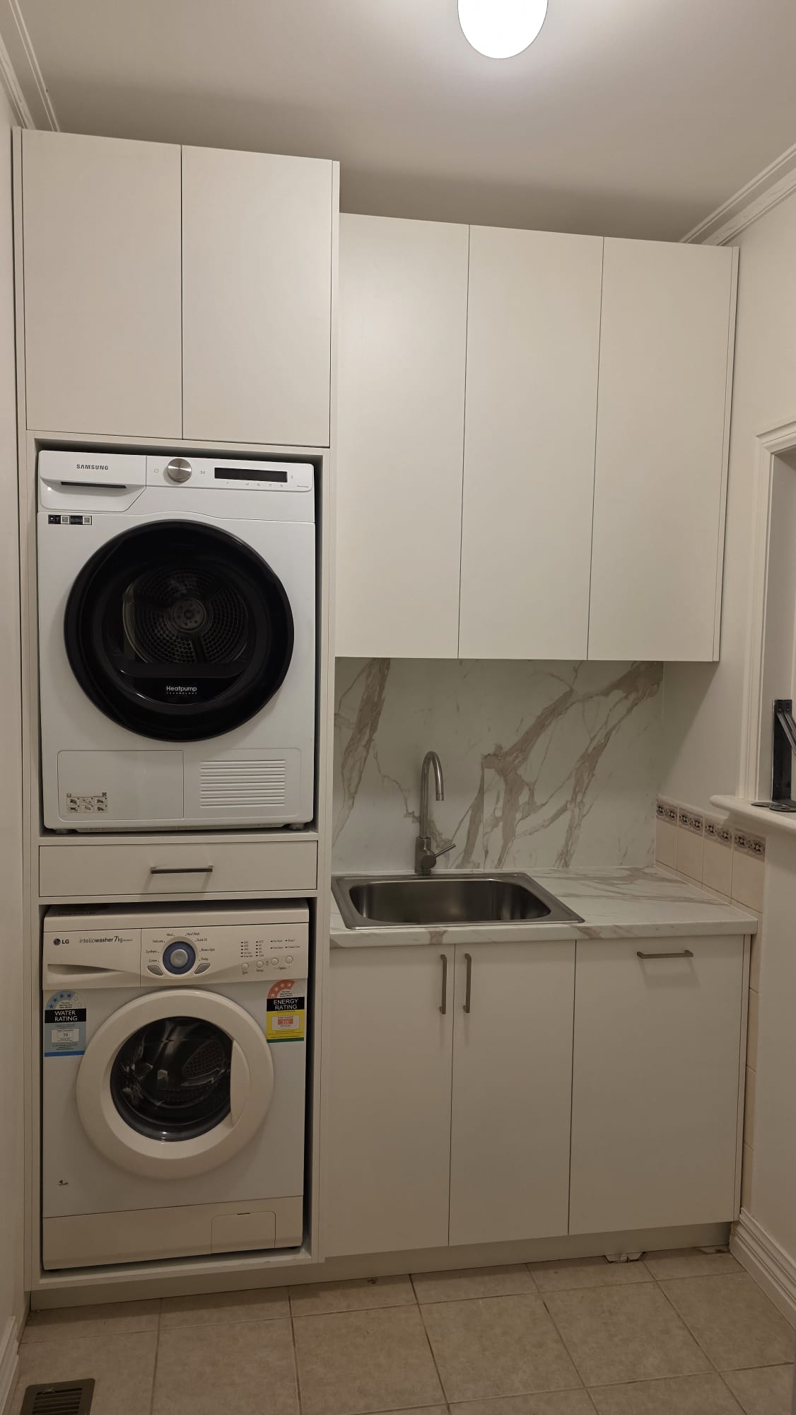 Completed compact custom laundry cabinetry